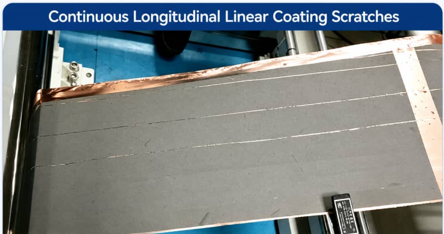 Continuous longitudinal coating scratches on a lithium-ion battery electrode sheet caused by blade clogging, slurry particle agglomeration, and coating head contamination during roll-to-roll coating.