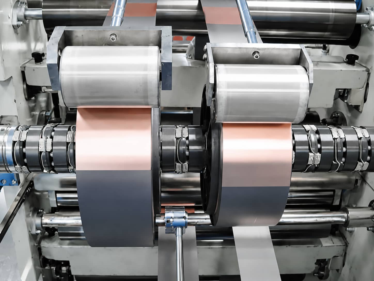 Lithium-ion battery electrode slitting process showing master roll cutting into smaller electrode rolls with controlled width for winding assembly.