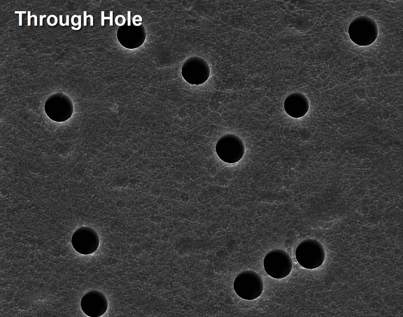 Surface SEM micrograph of a cellulose battery separator showing distributed straight through-holes for ion transport.