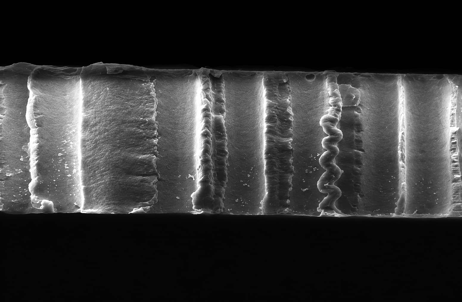 Cross-sectional SEM image of a cellulose battery separator showing its layered internal structure and through-thickness channels.